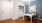 an entrance area with a table, mirror and a washer and dryer set