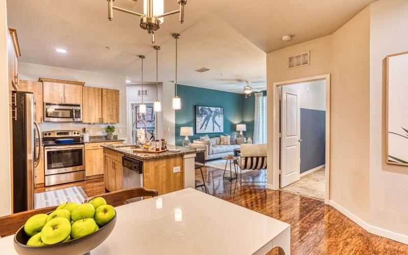 a kitchen with a large island and a living room