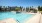 a swimming pool with a building in the background