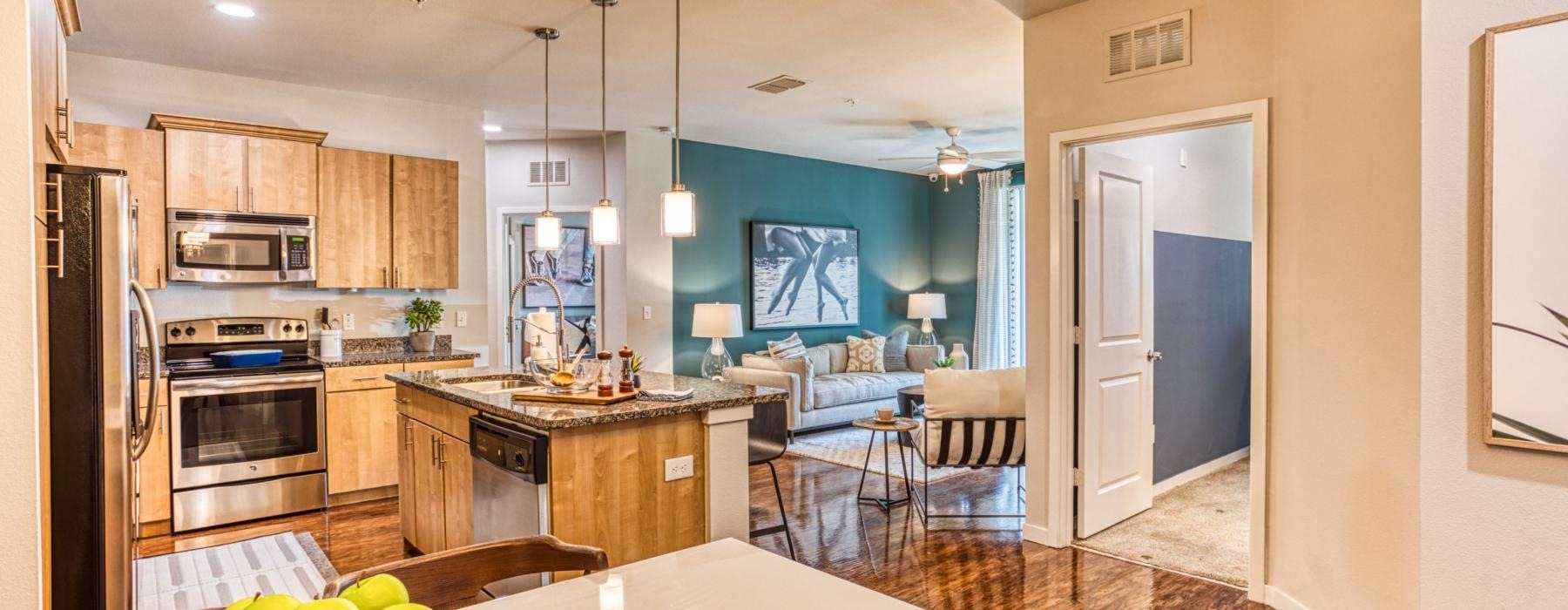 a kitchen with a large island and a living room